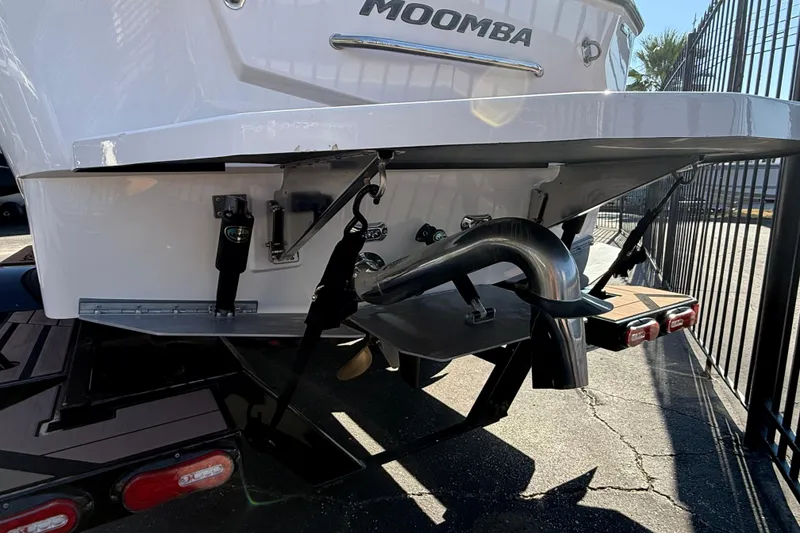 Slide: The Image of Rear view of 2021 Moomba Max boat, showcasing exhaust and trim details. - 2
