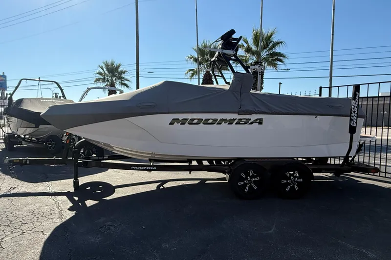 Slide: The Image of 2021 Moomba Max boat with cover on trailer, parked outdoors. - 5