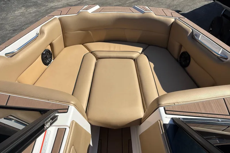 Slide: The Image of 2021 Moomba Max boat interior with tan seating and built-in speakers. - 7