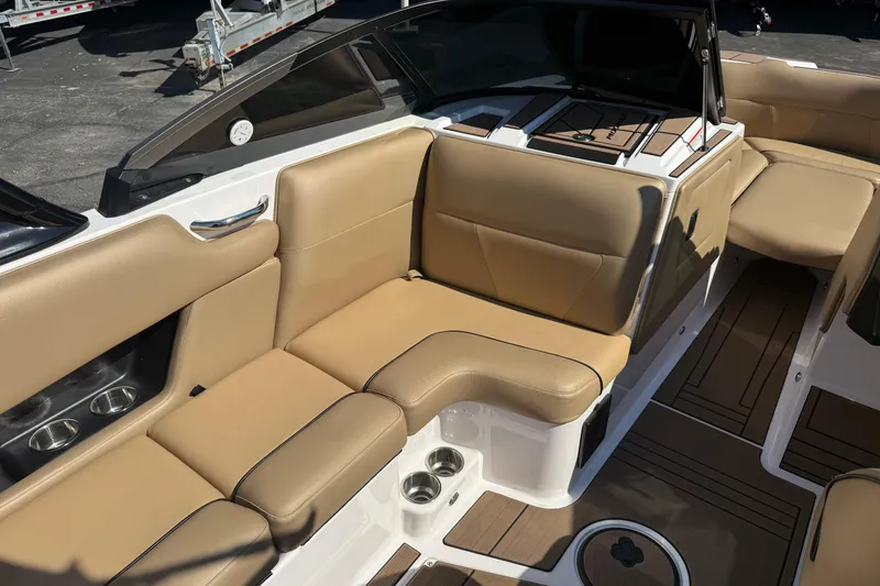 Slide: The Image of 2021 Moomba Max boat interior with tan seating and cup holders. - 9