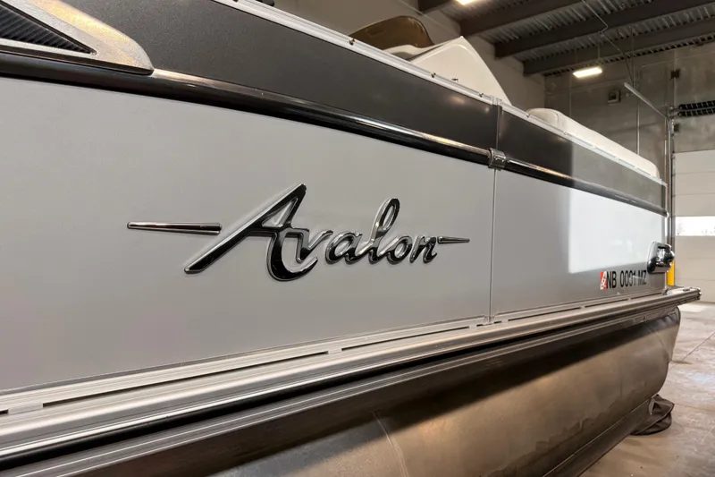 Slide: The Image of 2023 Avalon Catalina Platinum Rear J Lounge boat in a warehouse setting. - 14