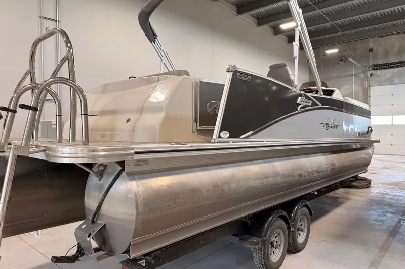 Slide: The Image of 2023 Avalon Catalina Platinum Rear J Lounge pontoon boat in a showroom. - 3