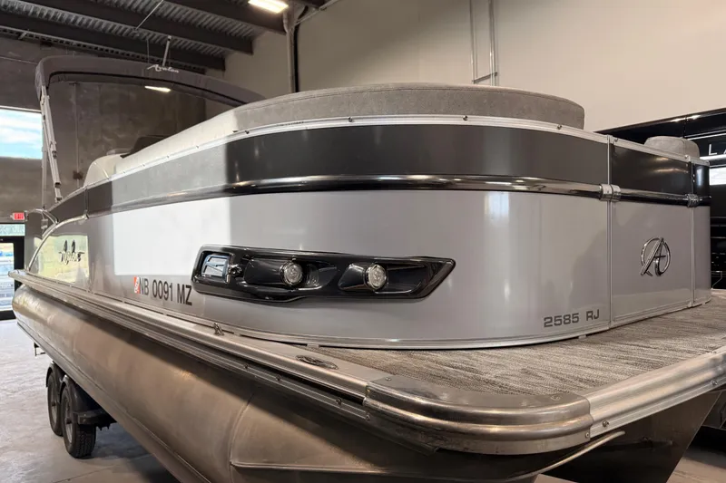 Slide: The Image of 2023 Avalon Catalina Platinum Rear J Lounge pontoon boat in showroom, side view. - 4