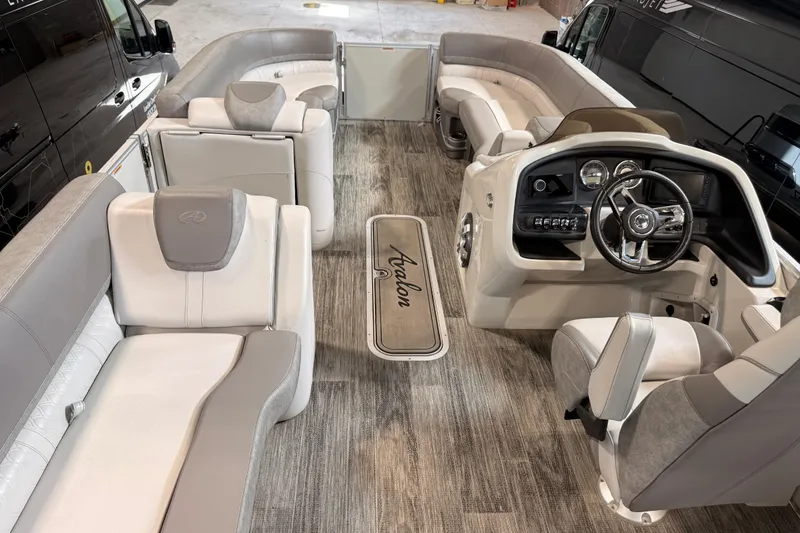 Slide: The Image of 2023 Avalon Catalina Platinum Rear J Lounge boat interior with luxurious seating and modern dashboard. - 5