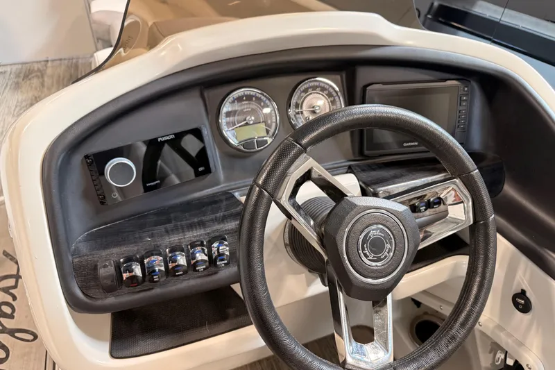 Slide: The Image of Steering console of 2023 Avalon Catalina Platinum Rear J Lounge boat, featuring modern controls. - 8
