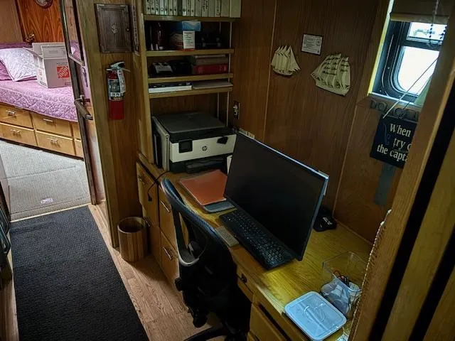 Slide: The Image of Office space inside a 1991 Florida Bay Coasters 53 Trawler, featuring a desk and computer setup. - 10