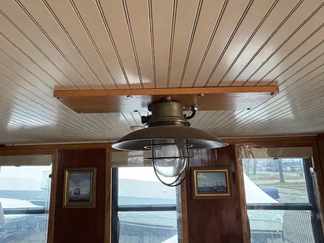 Slide: The Image of Ceiling light fixture inside 1991 Florida Bay Coasters 53 Trawler with wood paneling and framed art. - 14