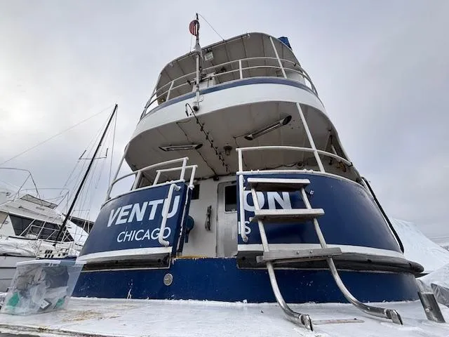 Slide: The Image of 1991 Florida Bay Coasters 53 Trawler docked, rear view with Chicago markings. - 16