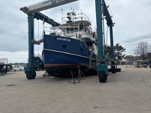 Slide: The Image of 1991 Florida Bay Coasters 53 Trawler in dry dock, named "Venture On." - 4