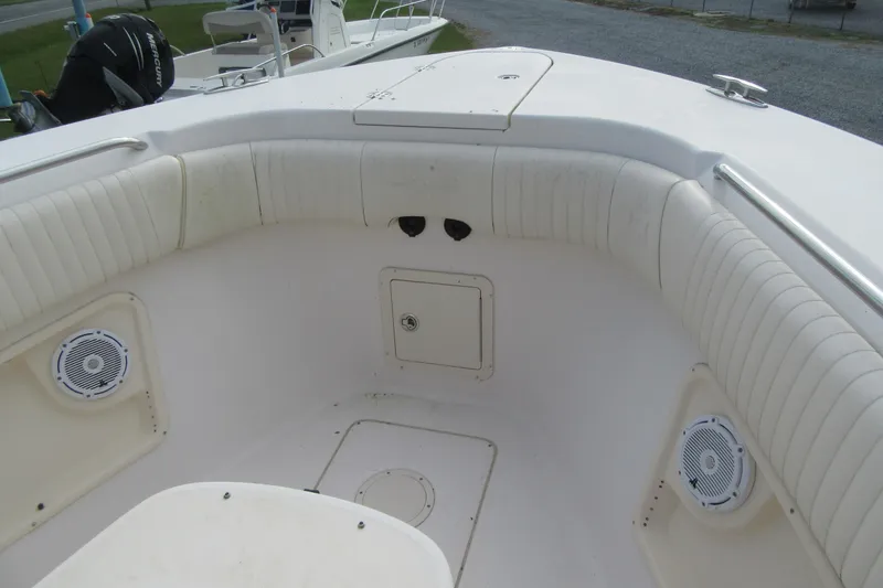 Slide: The Image of 2012 Grady-White Canyon 271 boat interior with cushioned seating and speakers. - 10