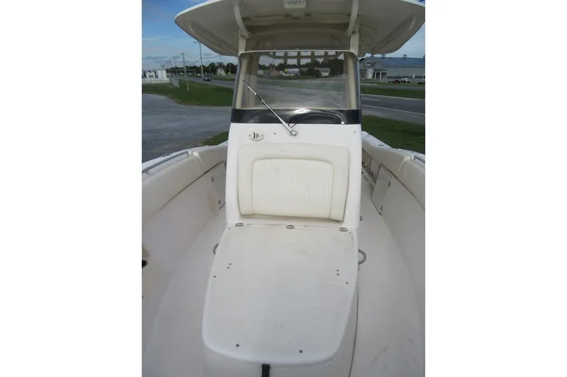 Slide: The Image of 2012 Grady-White Canyon 271 boat interior with seating and console, parked outdoors. - 13
