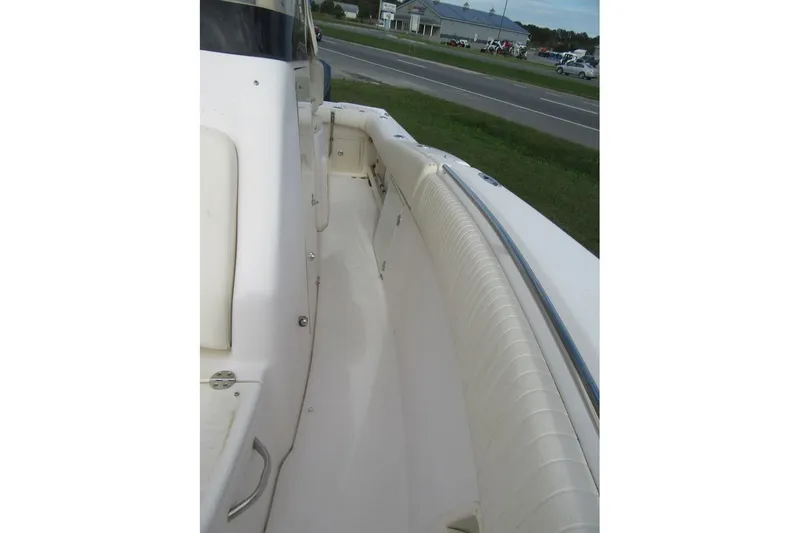 Slide: The Image of 2012 Grady-White Canyon 271 boat interior with cushioned seating and clean deck. - 14