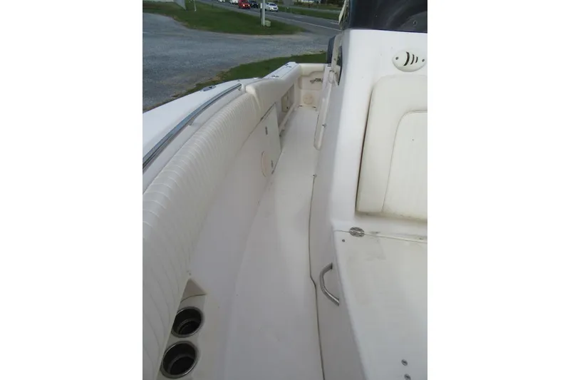 Slide: The Image of 2012 Grady-White Canyon 271 boat interior with seating and cup holders. - 15