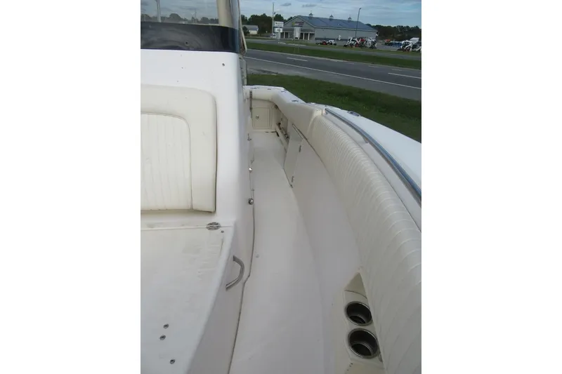 Slide: The Image of 2012 Grady-White Canyon 271 boat interior with white seating and cup holders. - 17