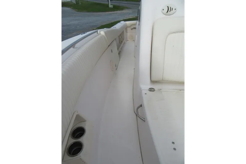 Slide: The Image of 2012 Grady-White Canyon 271 boat interior with seating and cup holders. - 18