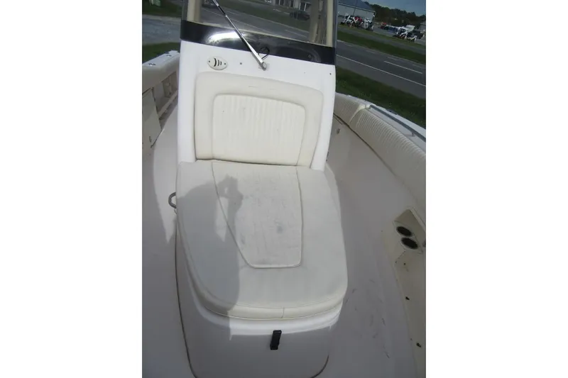 Slide: The Image of 2012 Grady-White Canyon 271 boat interior with cushioned seating and console. - 19