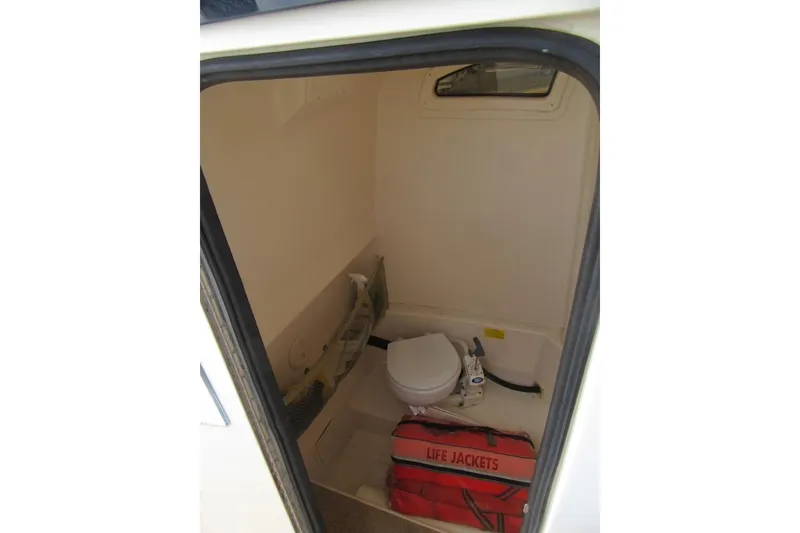 Slide: The Image of 2012 Grady-White Canyon 271 boat interior with toilet and life jackets. - 20