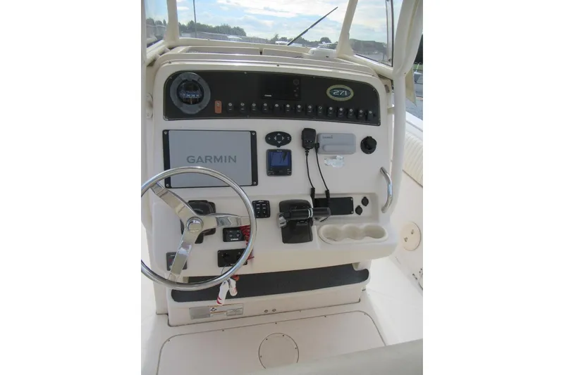 Slide: The Image of 2012 Grady-White Canyon 271 boat dashboard with Garmin navigation system. - 23