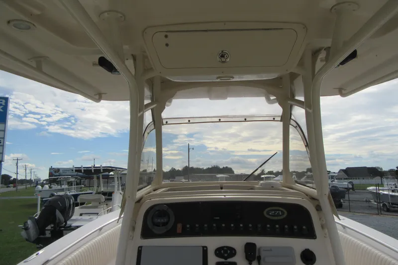 Slide: The Image of 2012 Grady-White Canyon 271 boat dashboard with clear sky background. - 24