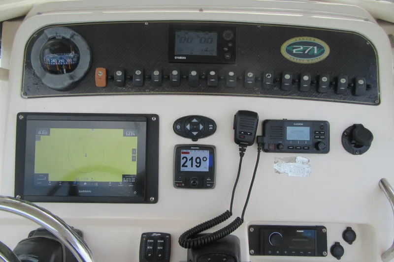 Slide: The Image of 2012 Grady-White Canyon 271 dashboard with navigation and communication equipment. - 25
