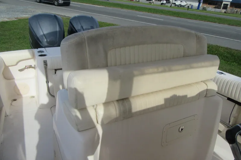 Slide: The Image of 2012 Grady-White Canyon 271 boat interior with seating and dual outboard motors. - 26