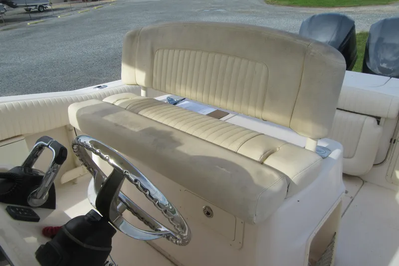 Slide: The Image of 2012 Grady-White Canyon 271 boat interior with steering wheel and seating. - 27