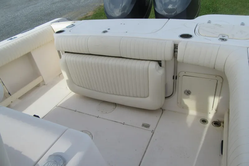 Slide: The Image of 2012 Grady-White Canyon 271 boat interior with foldable seating and storage compartments. - 28
