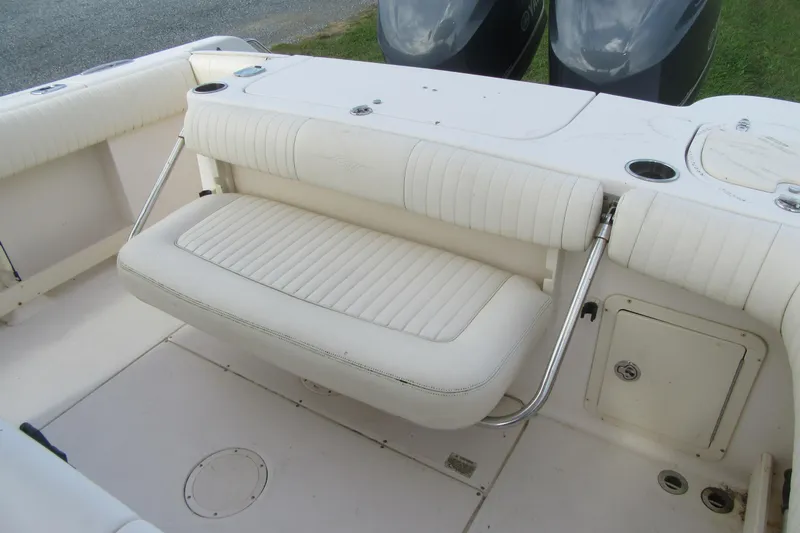 Slide: The Image of 2012 Grady-White Canyon 271 boat with white cushioned seating and stainless steel supports. - 30