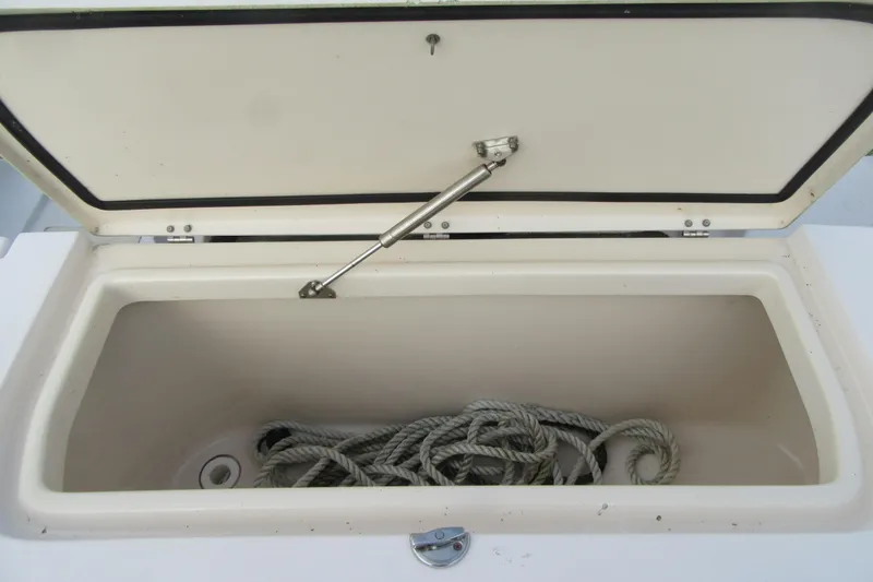 Slide: The Image of Open storage compartment with rope on a 2012 Grady-White Canyon 271 boat. - 33