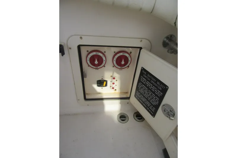 Slide: The Image of 2012 Grady-White Canyon 271 boat battery control panel with dual switches and operation instructions. - 35
