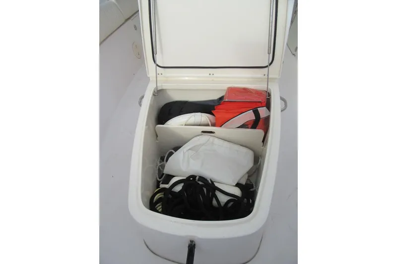 Slide: The Image of Open storage compartment on 2012 Grady-White Canyon 271 boat, containing life jackets and ropes. - 38