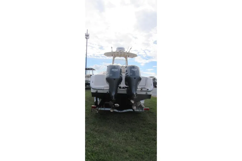 Slide: The Image of 2012 Grady-White Canyon 271 boat with dual outboard motors, rear view. - 4