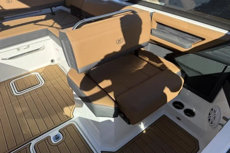 Slide: The Image of 2022 Cobalt R6 boat interior with tan seating and wood-patterned flooring. - 10