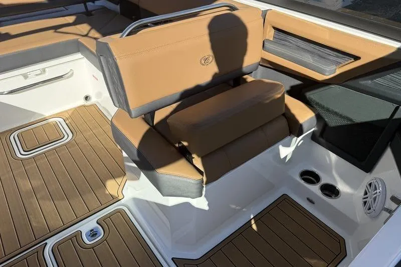 Slide: The Image of 2022 Cobalt R6 boat interior with tan seating and wood-style flooring. - 11