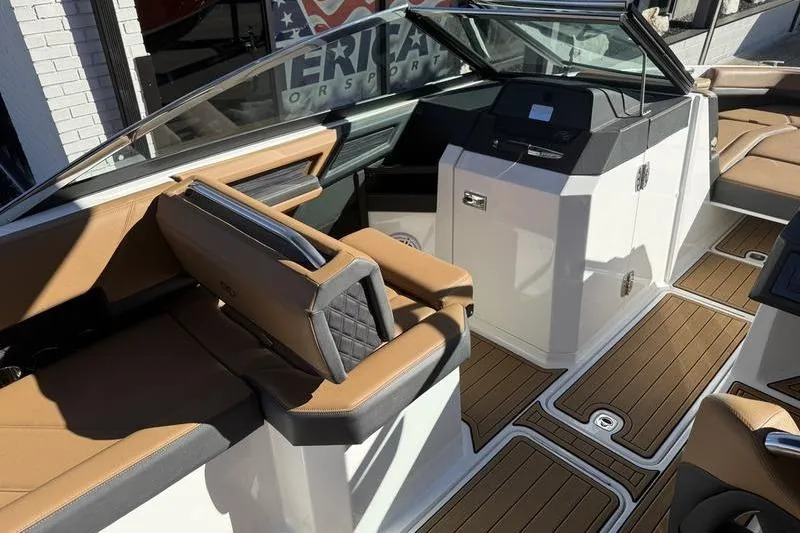 Slide: The Image of 2022 Cobalt R6 boat interior with tan seating and modern dashboard design. - 12