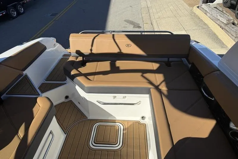 Slide: The Image of 2022 Cobalt R6 boat interior with tan seating and wood accents. - 14