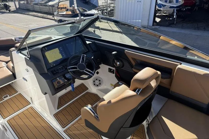 Slide: The Image of 2022 Cobalt R6 boat interior with modern dashboard and tan seating. - 19