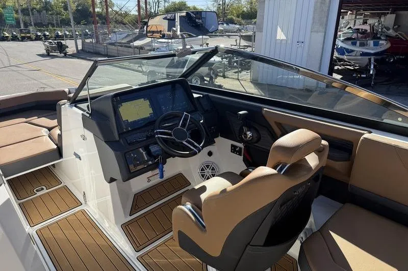 Slide: The Image of 2022 Cobalt R6 boat interior with modern dashboard and tan seating. - 20