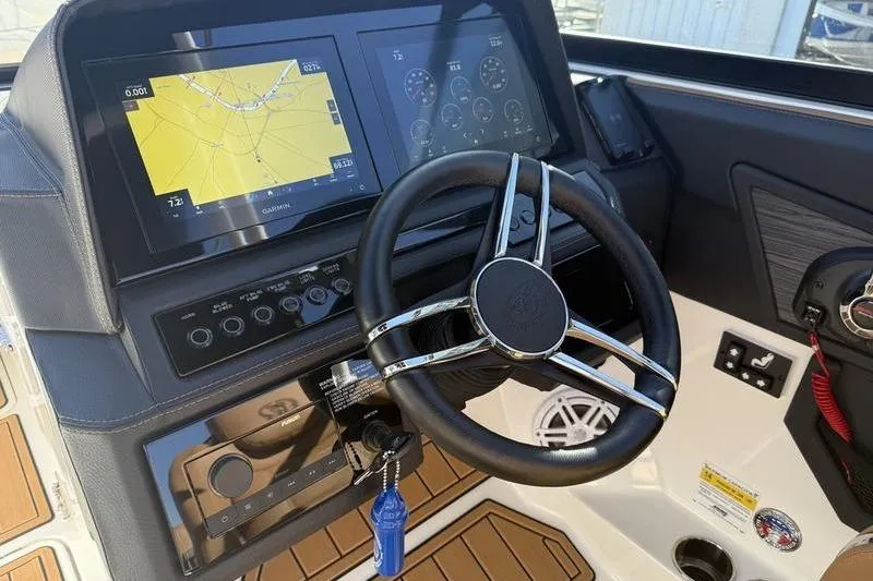 Slide: The Image of 2022 Cobalt R6 boat dashboard with steering wheel and navigation screens. - 22