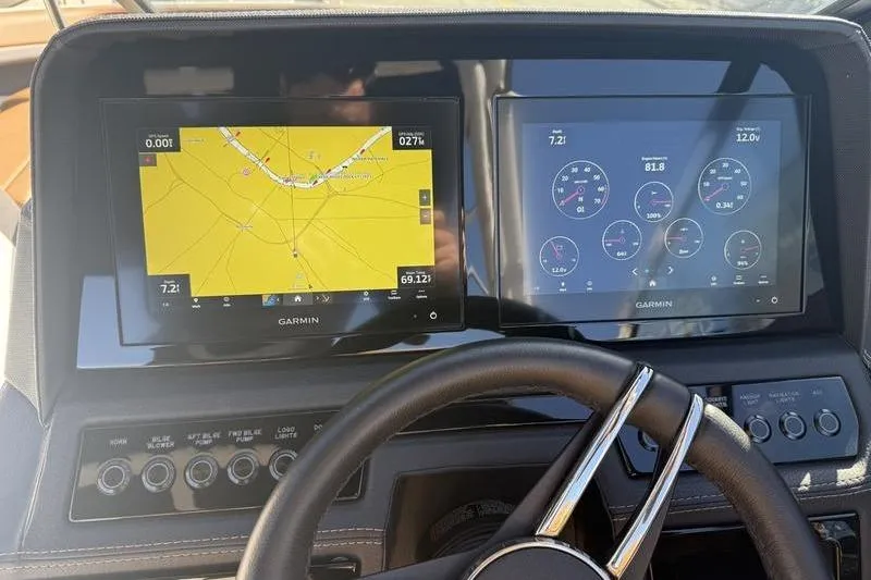 Slide: The Image of Dashboard of a 2022 Cobalt R6 boat with Garmin navigation and control screens. - 23