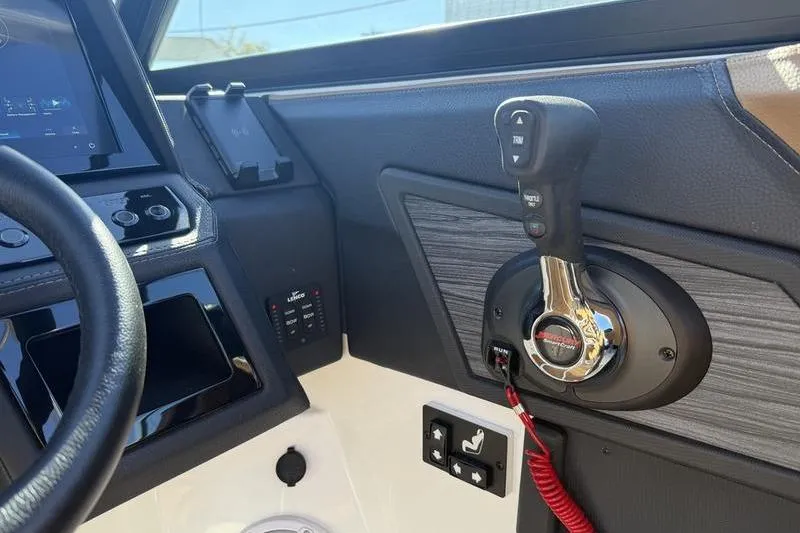 Slide: The Image of 2022 Cobalt R6 boat dashboard with control panel and throttle lever. - 24