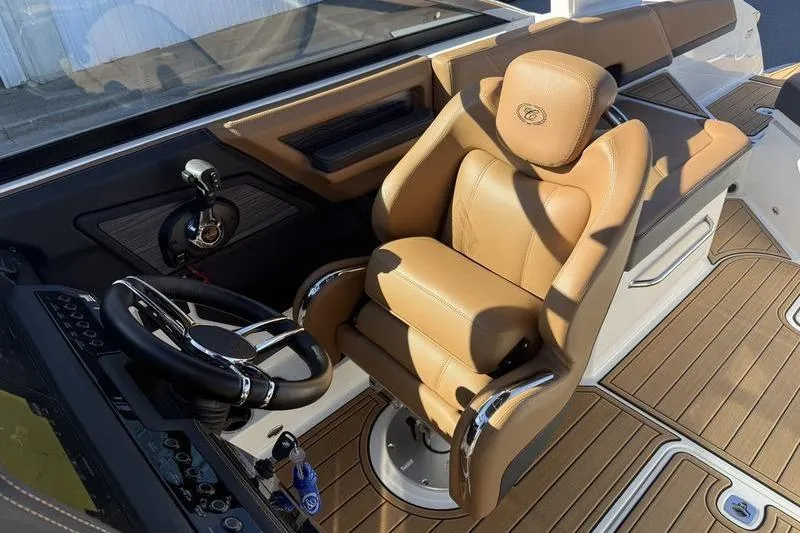 Slide: The Image of Luxurious 2022 Cobalt R6 boat interior with tan leather seating and modern steering controls. - 26