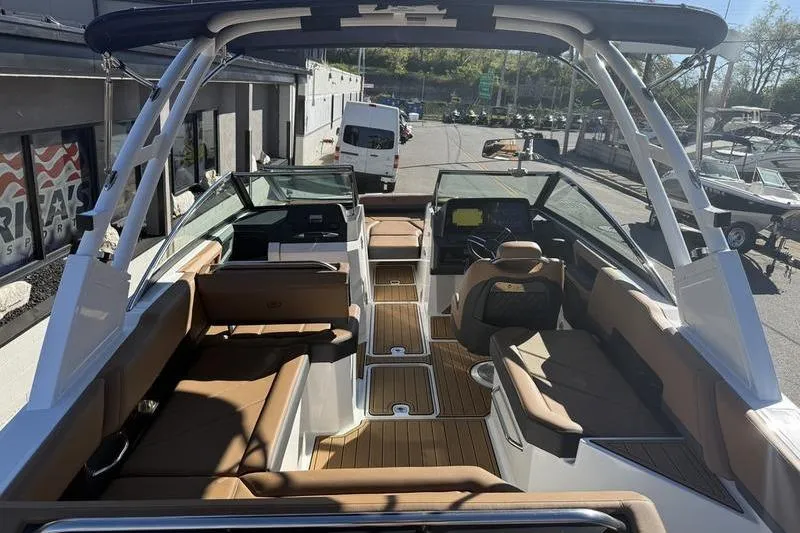 Slide: The Image of 2022 Cobalt R6 boat interior with brown seating and modern dashboard. - 29