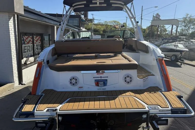 Slide: The Image of 2022 Cobalt R6 boat with teak deck and cushioned seating, displayed outdoors. - 31