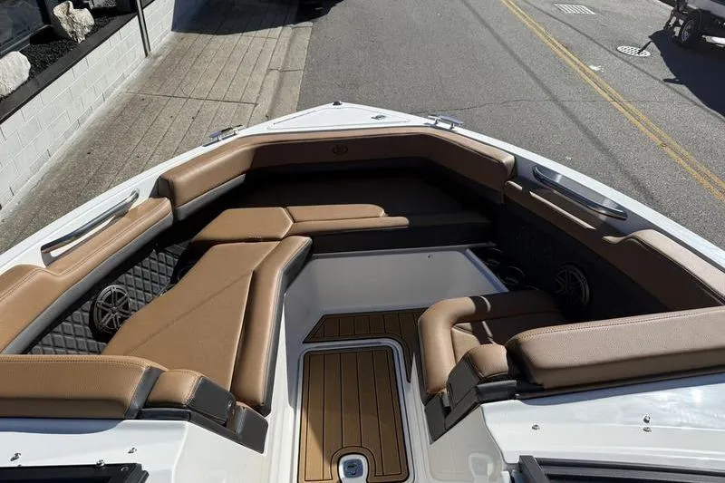 Slide: The Image of 2022 Cobalt R6 boat interior with tan seating and wood flooring. - 6