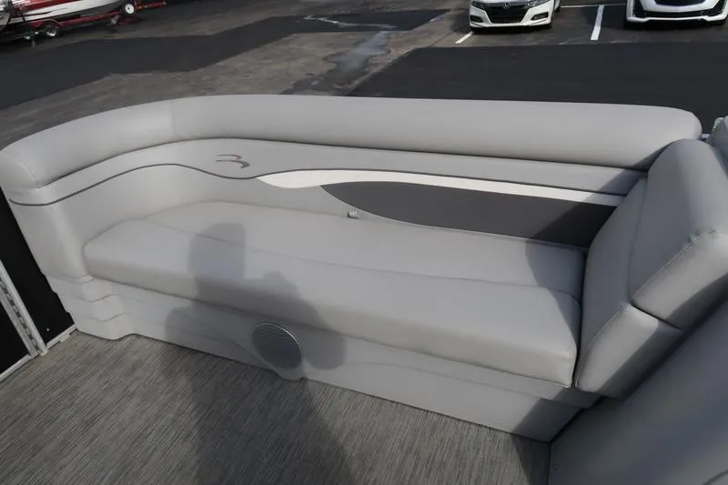 Slide: The Image of 2020 Bennington 20 SLMX pontoon boat interior with gray seating and speaker. - 10