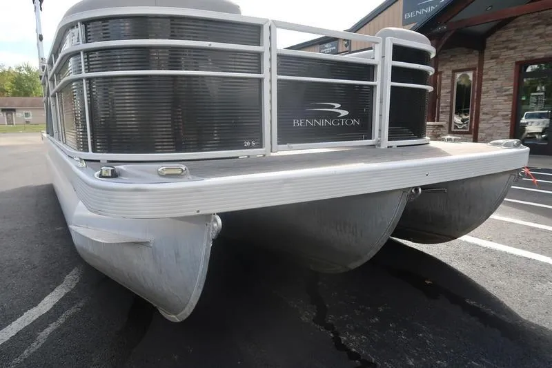 Slide: The Image of 2020 Bennington 20 SLMX pontoon boat parked on pavement. - 11