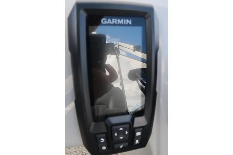 Slide: The Image of Garmin device on 2020 Bennington 20 SLMX boat dashboard, reflecting sky and structure. - 12