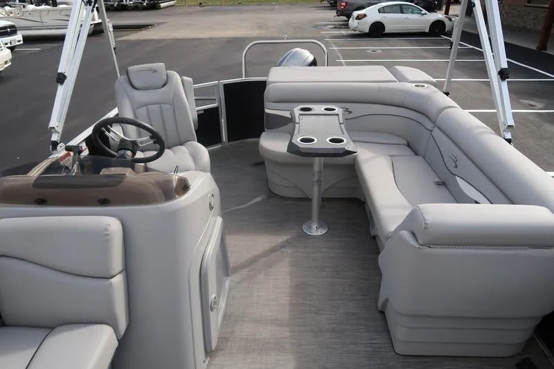 Slide: The Image of 2020 Bennington 20 SLMX pontoon boat interior with gray seating and steering console. - 16