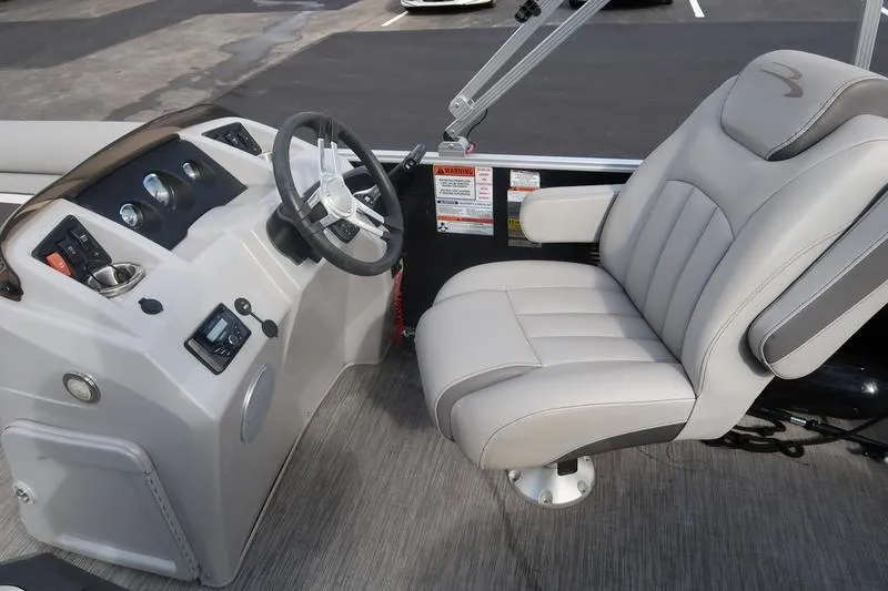 Slide: The Image of 2020 Bennington 20 SLMX boat interior with steering wheel and captain's chair. - 17